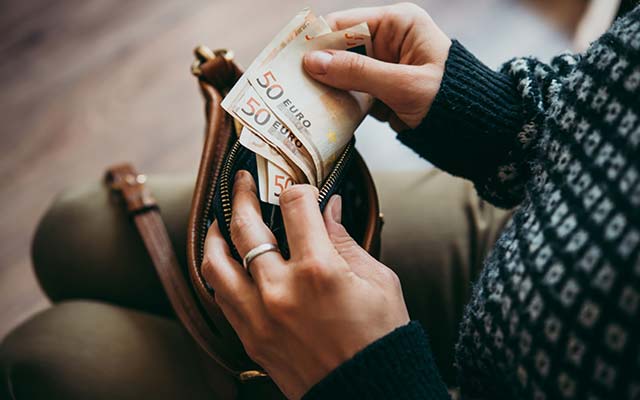 Frau verdient Geld mit Zeitungen austragen